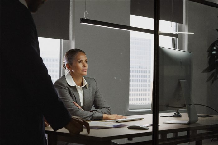 A woman doing the work but overlooked in the room